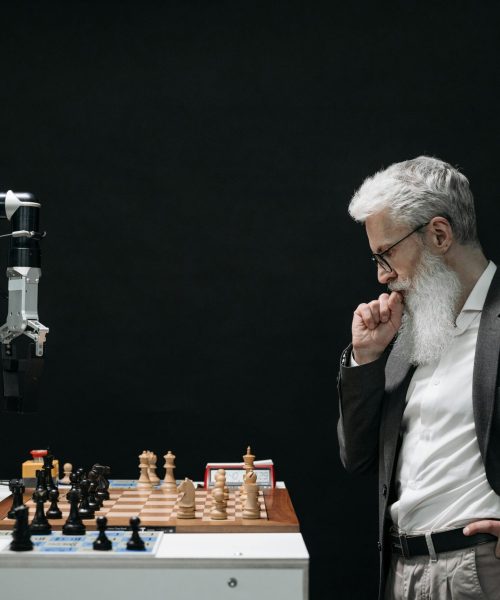 Elderly Man Thinking while Looking at a Chessboard